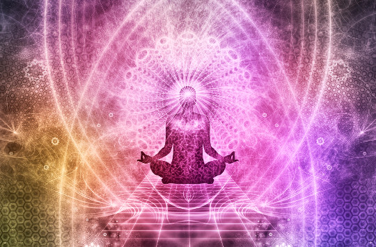image of a person sitting in meditation surrounded by light