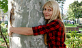 young woman hugging a tree